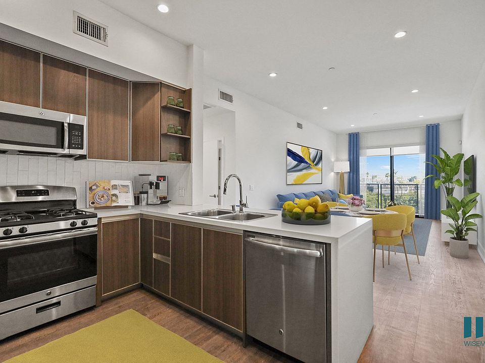 Open-Concept Kitchen, Dining, and Living Room Space with Patio