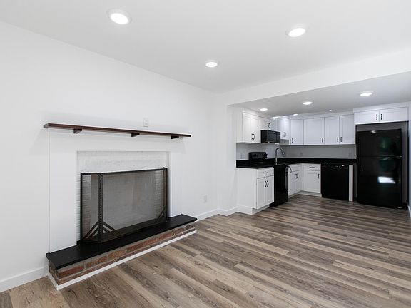 Open floor plan living room and kitchen. Cherry mantle and granite hearth.
