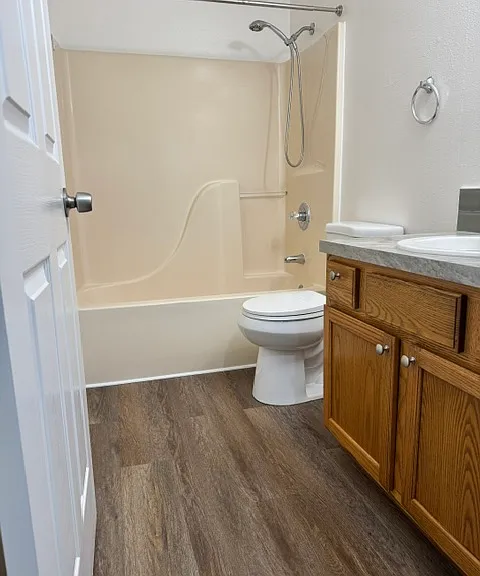 Tub and shower in the updated hallway bathroom with newer vanity and flooring!