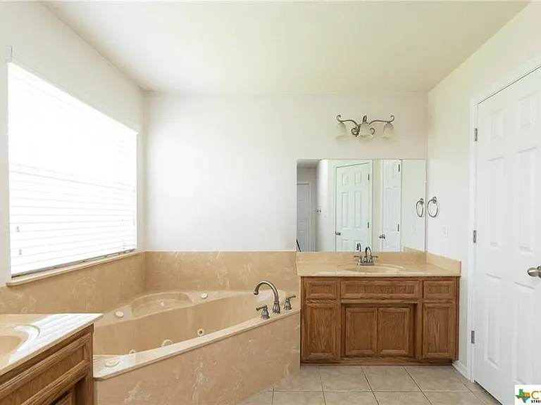 Master bath. His and her sink areas and large corner soaking jetted tub.