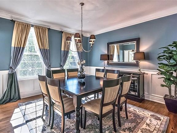 Elegant formal dining room with wainscoting (new), crown molding (new) and pottery barn colors.