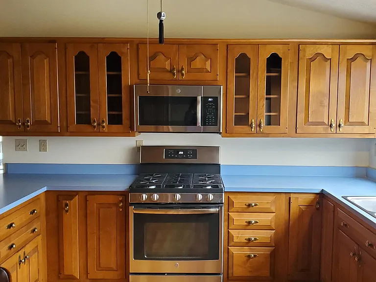 Kitchen with Woodmode cabinents, GE gas stove, above stove microwave oven