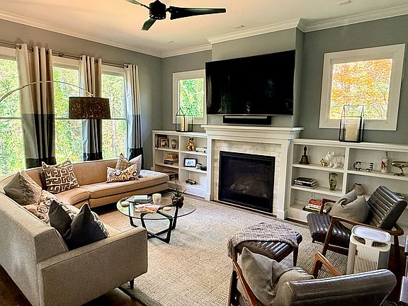 Great room is filled with light and complete with a gas log fireplace and built-ins
