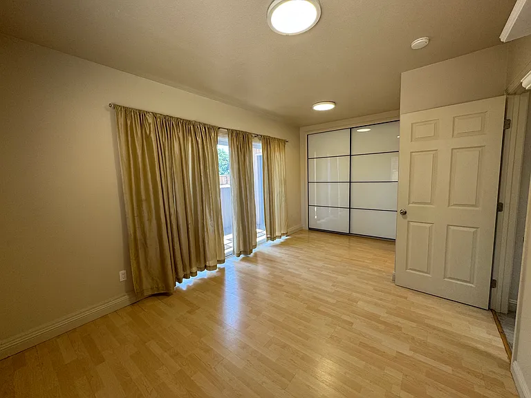 downstairs master bedroom with private patio (behind curtain)