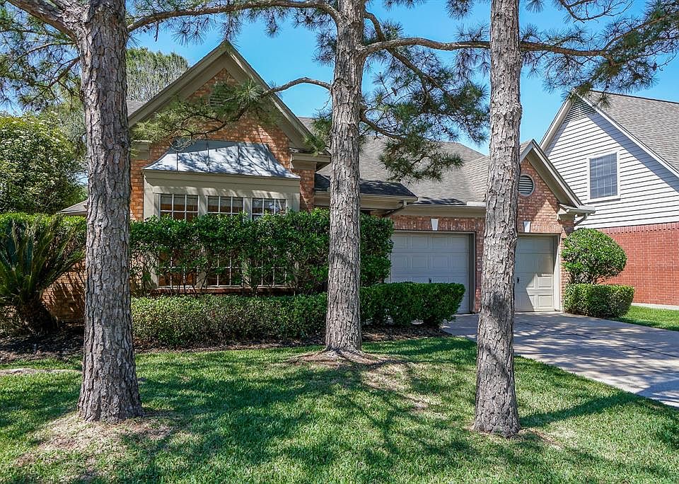 Mature trees provide shade and double wide driveway provides ample parking.