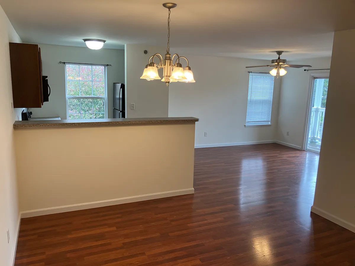 View from entry way. Master bedroom is to the left. Living room visible in the back. Dining area is front and centered. - 12200 Spring Creek Ln