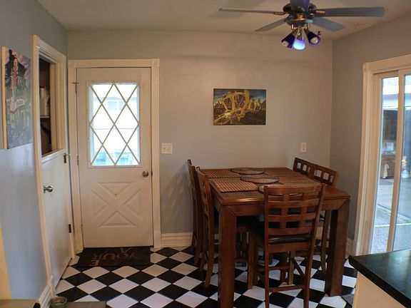 Kitchen entry space with checkered tiled floors. A must see!