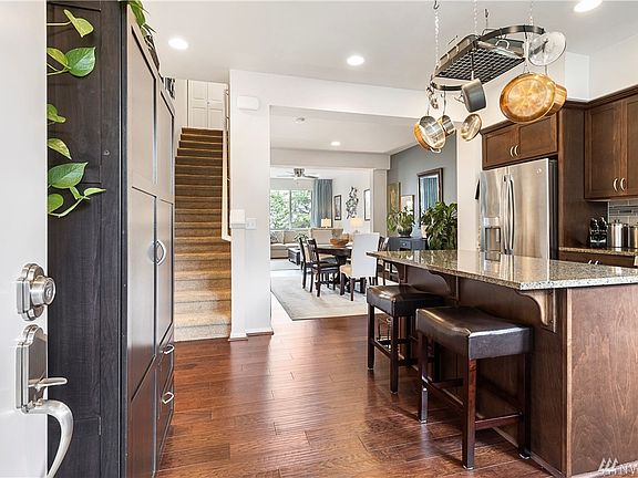 This home is stunning! Enter into the beautiful kitchen with engineered hardwoods, stainless appliances and large island with slab granite.