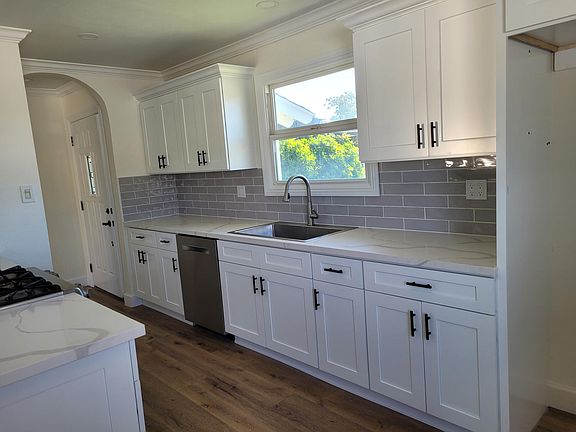 NEW: Cabinets, countertops, backslash, flooring & dishwasher.
