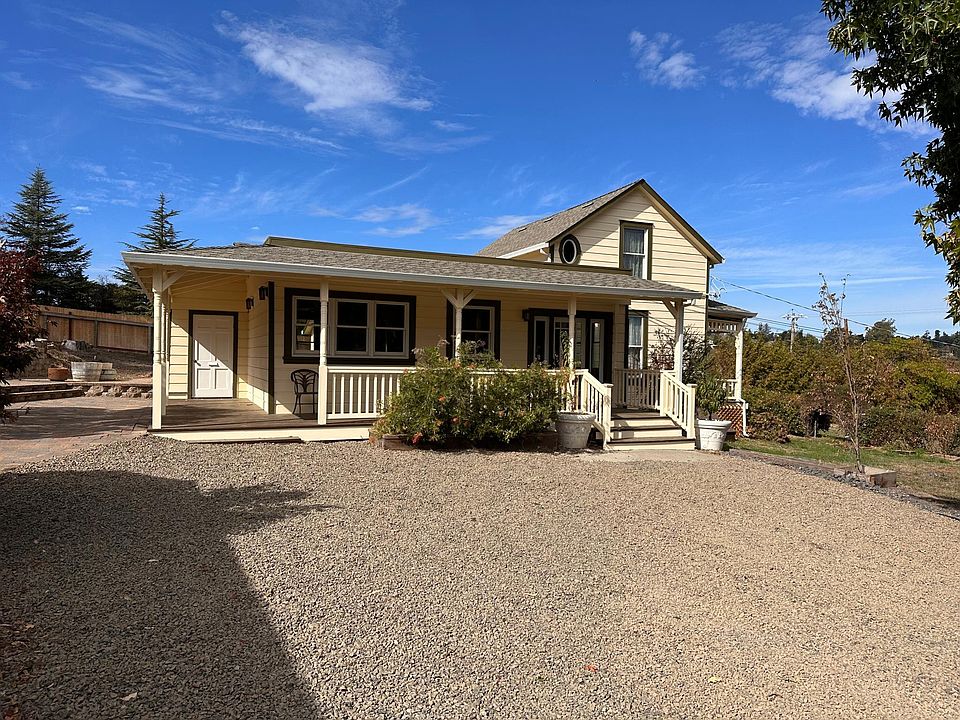 Main house from Parking area. Front door at top of steps. Mudroom/other entrance on the left.