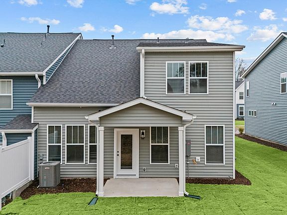 Highly functional rear covered porch adds memorable living space to this elegant home