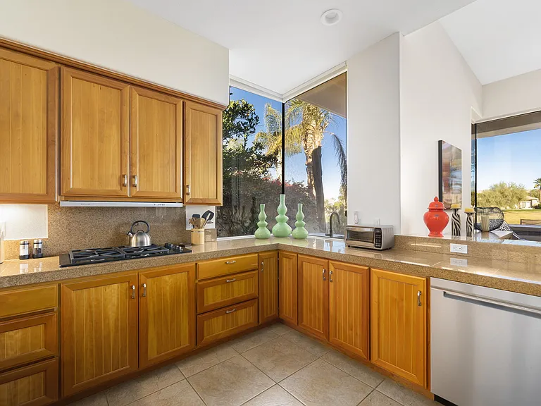 Kitchen area looking out to golf course and pool.