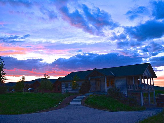 Front entrance and double oversized garage under porch. Parking pad in front of the truck for oversized/extra vehicles...