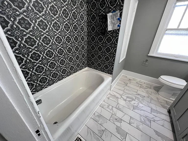 all tiled and with linen closet