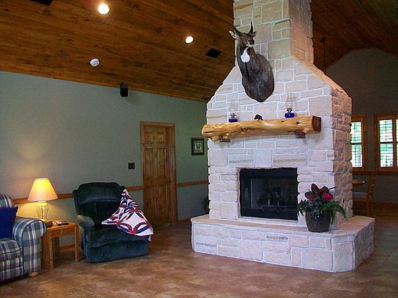 WELCOME TO THIS AMAZING RANCH WITH TWO SIDED LIME STONE FIREPLACE, & ASPEN WOOD CEILING