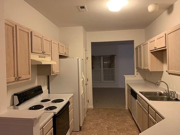 Kitchen opens to living room and dining room with breakfast area