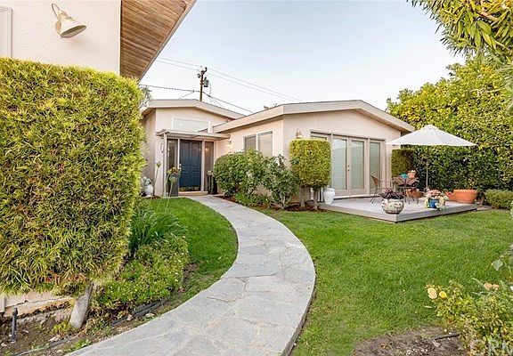 Front of house is private and has a grassy yard plus a deck