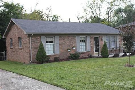 Front elevation. Lovely ranch, well manicured lawn.