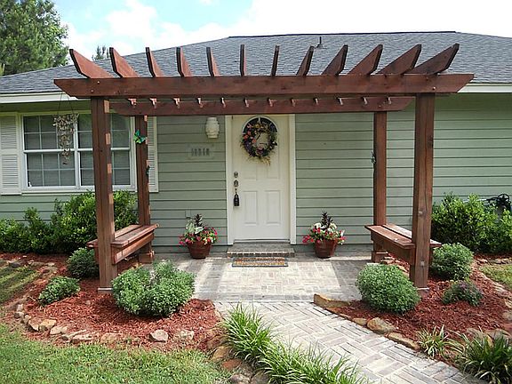 The arbor adds more charm to the home.