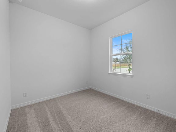 Spacious secondary retreat featuring soft carpet and abundant natural light.