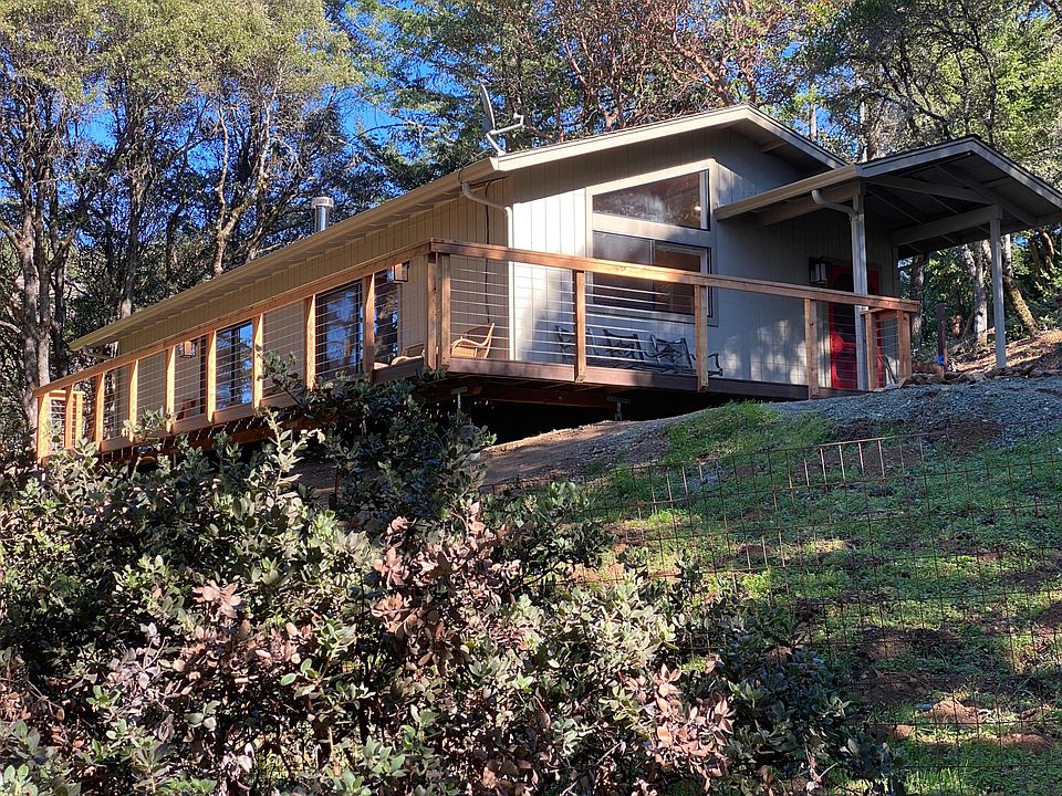 The cottage front door (on right) and wrap-around deck.