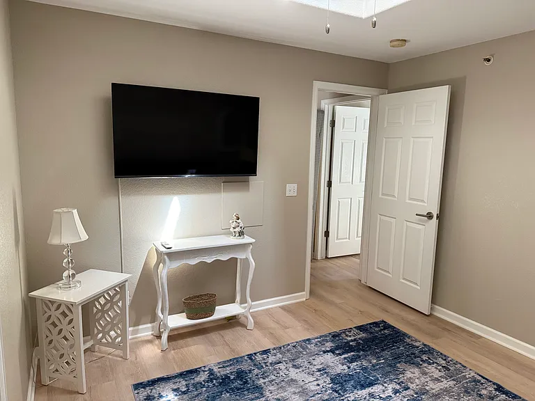Den with flat screen tv , sofa that opens to queens size bed. Skylight and full closet.