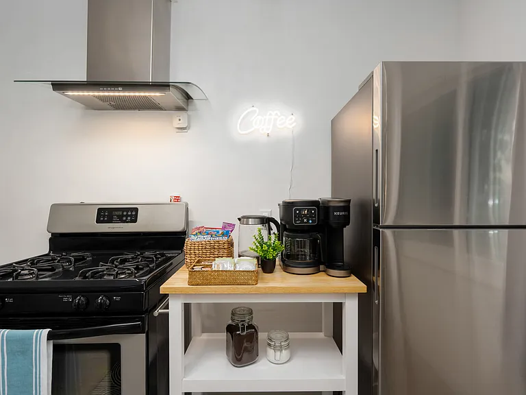 Key appliances include a stainless-steel oven, a full-sized fridge, and a convenient Keurig coffee maker.