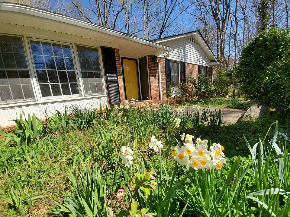 Flowers bed near front of house. You'll find flowers, plants, and beautiful woods throughout the 1.7 acre property