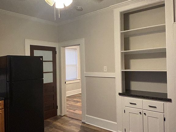 Standing in middle of the Eat-in-Kitchen facing the back entrance door (door on left) and 3rd bedroom (door to the right)