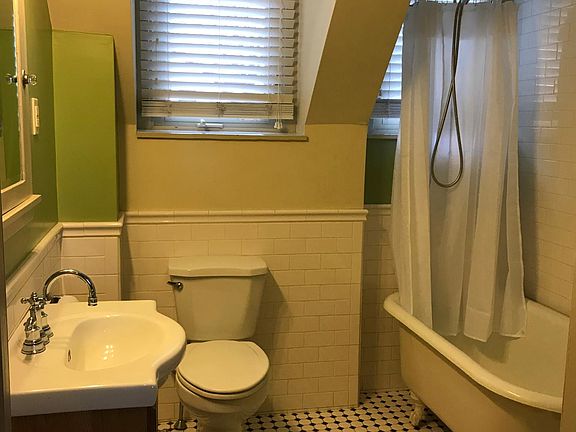 Ceramic-tiled bath, original clawfoot tub has been newly resurfaced