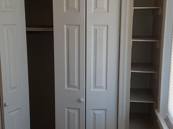 Master bedroom custom shelving for shoes/accessories and double bifold closet