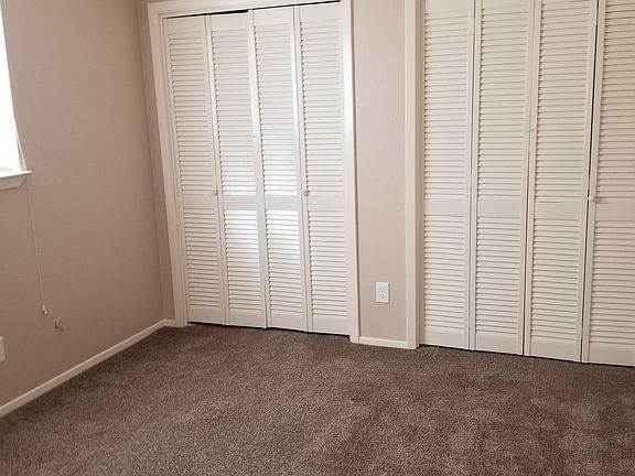 master bedroom. Two closets, carpet, ceiling fan.