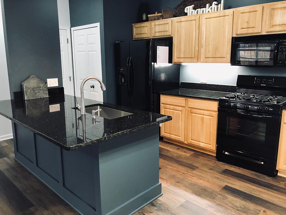 Granite countertops and deep stainless steel sink, undercabinet lighting