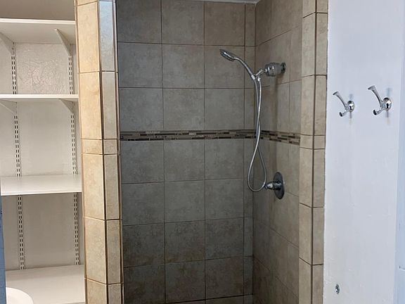Unit has a 3/4 Bathroom which means walk-in shower but no bathtub. Beautifully tiled and with tons of storage; it also has a new bathroom fan and lights.