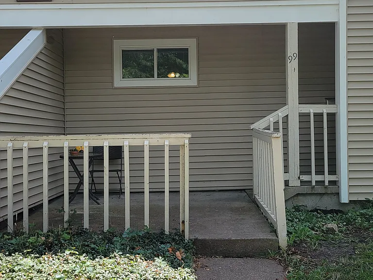 The front of the house includes a patio and low maintenance plants. All windows are new in the home and the siding was newly installed.