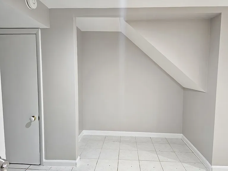 Nook under basement stairwell perfect for storage or TV, get creative with this large space!