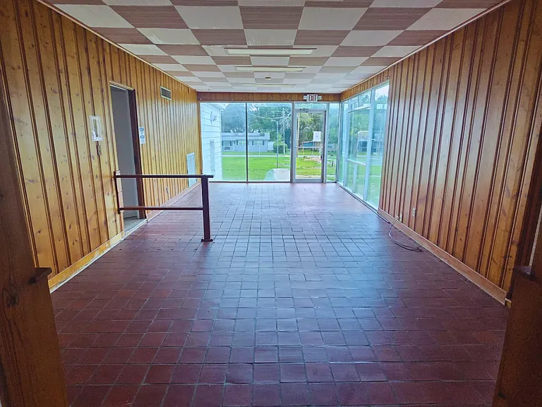 Expansive gathering area with floor-to-ceiling windows and outdoor views.