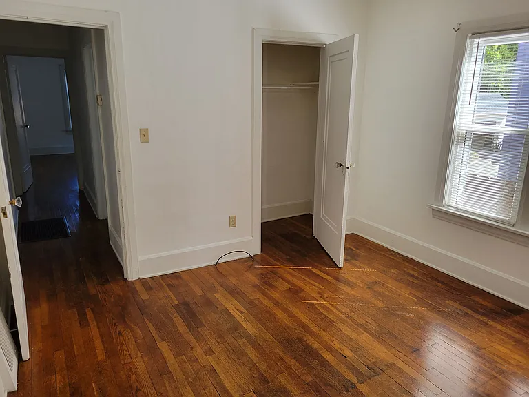 Second bedroom leading to closet and hallway to bathroom, bedrooms and dining room.