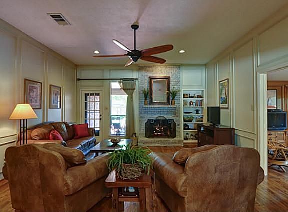 Enjoy the cozy Brick Fireplace plus convenient access to the Patio  & Yard!