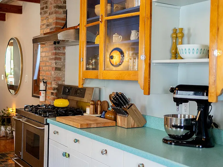 ____ Explore our mid-century-style kitchen featuring a Kitchenaid mixer for vintage charm. A perfect spot for culinary creations. ____