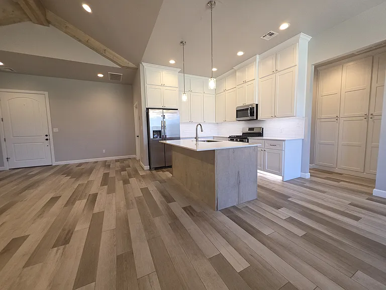 Open concept living with storage in the hallway