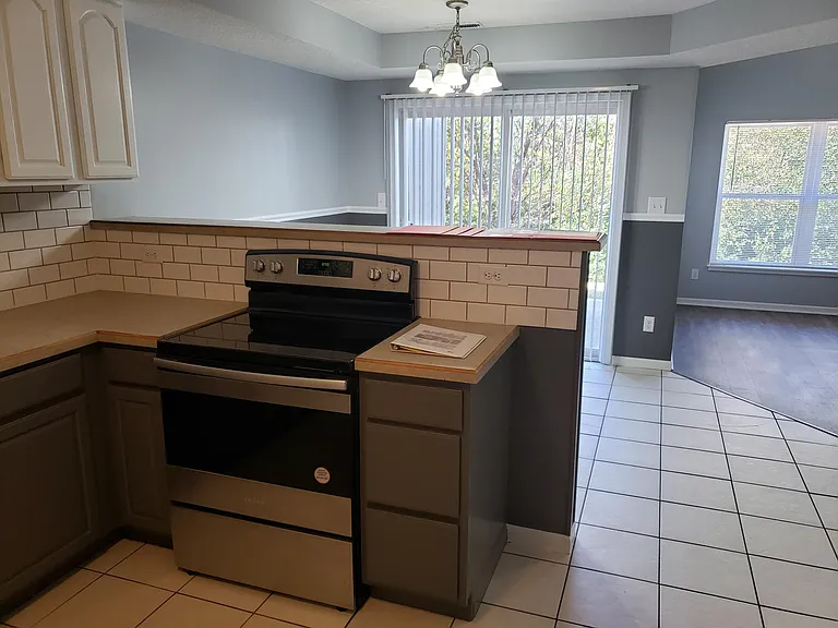 View of dining room and back patio from kitchen