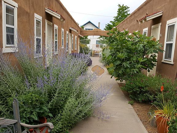Interior courtyard with flowers, plants, herbs.