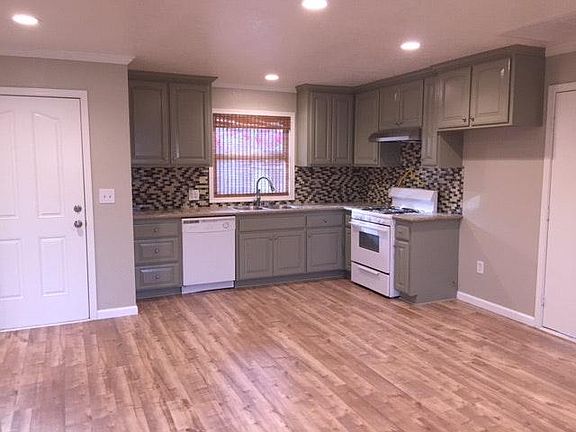 Beautiful sage cabinets with granite countertops. Dishwasher. Glass tile backsplash. Recessed lights throughout house.