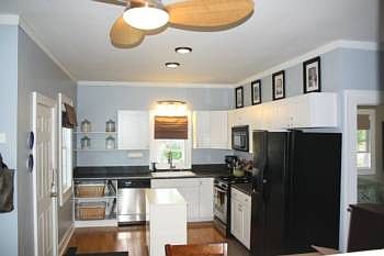 Fantastic country sized kitchen features bamboo hardwood flooring, crown molding, white cabinetry, and all appliances. 