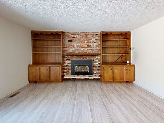 Living room features a view of the golf course  and access to a large deck and back yard.>