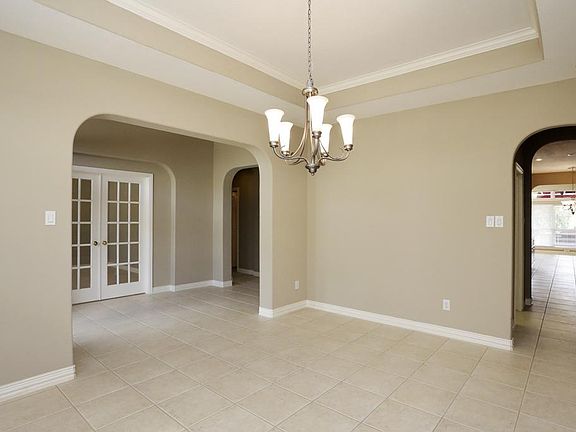 VIEW FROM FORMAL DINING INTO ENTRY AND KITCHEN