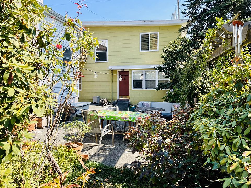 Front of the house from the garden, with the outdoor patio in view.