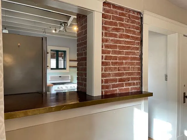 Peek a boo bar window from the dining room into the kitchen area is perfect serving spot
