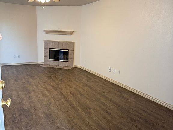 From entrance door to LR - showing fireplace and hall/kitchen.. on left of this photo